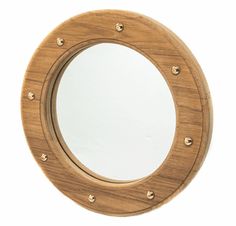 a wooden mirror with brass rivets on the edge and a white back ground