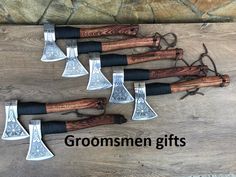 five different types of axes on a wooden table with the words, groomsmen gifts