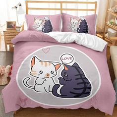 a bed with two cats on it and one cat has an i love you sign