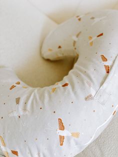 a donut shaped pillow sitting on top of a bed