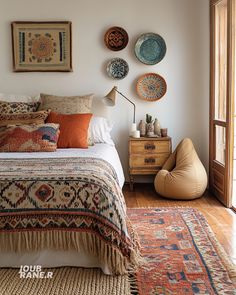 a bed sitting in a bedroom on top of a wooden floor next to a window