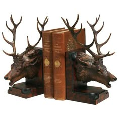 two bookends with deer heads on them and books in the shape of antlers