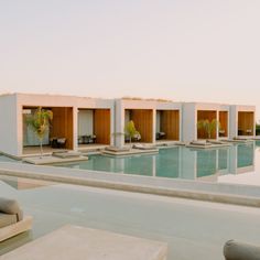 an empty swimming pool with lounge chairs around it