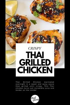 grilled chicken on a white plate with lemon wedges and cilantro garnish