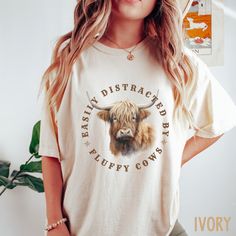 This Highland Cow Shirt / Cow Comfort Colors Shirt is perfect for the Cow lover in your life! So cute - it is sure to become a favorite!  ♥ W E L C O M E  T O  S K E T C H Y  C A T  D E S I G N S ! ♥ * This is a standard unisex garment-dyed 100% cotton shirt - Comfort Colors Tee with a relaxed fit. FOR AND OVERSIZED TEE, PLEASE SIZE UP!!  Please review the size chart to ensure you receive the fit you want. ♥ Click here to return to our shop's home page ⇒  https://www.etsy.com/shop/SketchyCatDesi Highland Cow Shirt, Farm Shirts, Animal Tshirt Design, Farmer Shirt, Cow Tshirt, Fluffy Cows, Cow Shirt, Cow Gifts, Cute Country Outfits