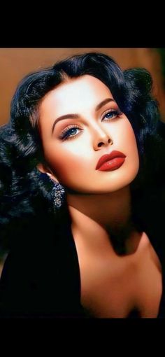 a woman with dark hair and red lipstick