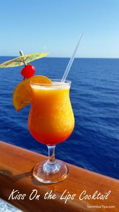 an orange drink with a straw garnish on the top