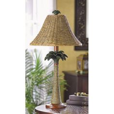 a lamp that is on top of a table with a potted plant in it