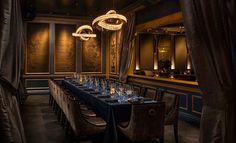 an elegant dining room set up with blue table cloths