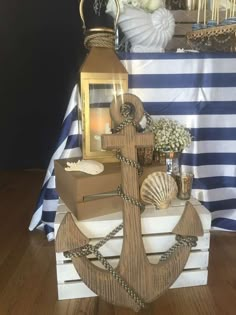 a wooden anchor with seashells and other items sitting on top of it in front of a table