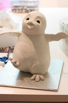 a white bird figurine sitting on top of a table