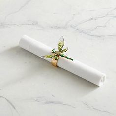 a white napkin with a gold dragon on it sitting on top of a marble counter