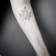 a single leaf tattoo on the arm