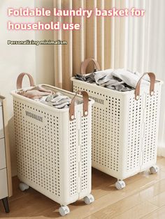 two white laundry baskets sitting next to each other on top of a hard wood floor