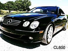 a black mercedes benz coupe parked in a parking lot