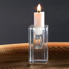 a candle that is sitting in a glass vase