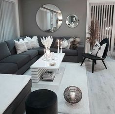 a living room filled with furniture and mirrors