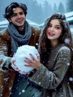 a man holding a snowball next to a woman