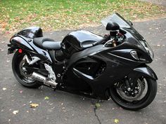 a black motorcycle is parked on the street