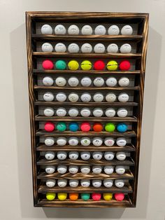 a wooden shelf filled with lots of different colored balls