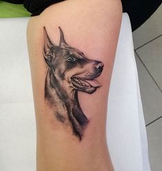 a dog's head is shown on the leg of a person with a tattoo