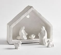 a nativity scene with three figurines in the shape of a house and a star