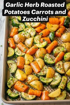 garlic herb roasted potatoes, carrots and zucchini in a baking pan with text overlay