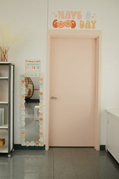 there is a pink door in the room that says have a good day on it