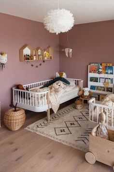 a bedroom with pink walls and white furniture in the room, including two twin beds