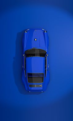 an overhead view of a blue sports car on a bright blue background with the hood down