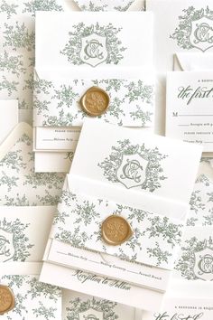 many different types of wedding cards and envelopes with wax stamp on them, all in green