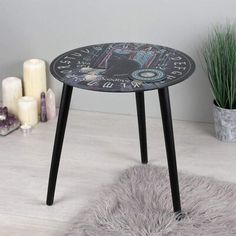 a small table with a clock design on it