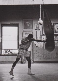 a poster with a man kicking a punching bag