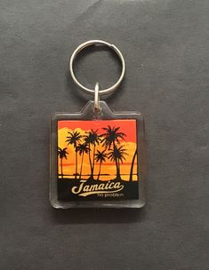 a keychain with an image of palm trees and the words jamaica on it