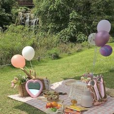 a picnic blanket with balloons and other items on it