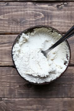 a scoop of ice cream in a bowl with two spoons