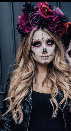 two people with face paint and flowers on their heads