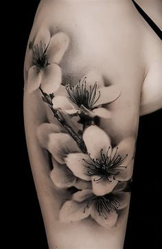 a woman's arm with flowers on it