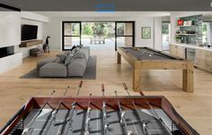 a living room filled with furniture and a pool table