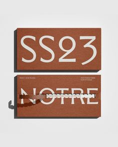 two brown and white business cards with the word sso23 printed on one side