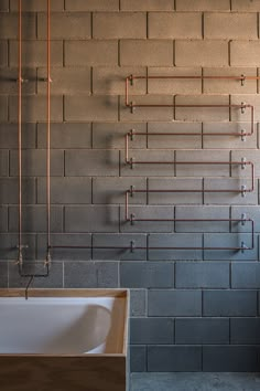 a white sink sitting next to a wall mounted faucet