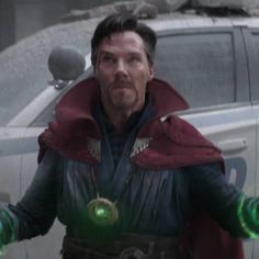 a man dressed as doctor strange standing in front of a car