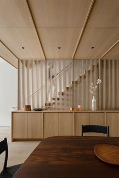 a dining room with wooden walls and chairs