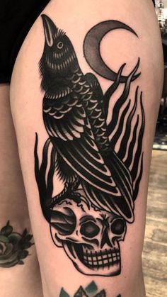 a black and white tattoo with a bird on top of a skull in the middle