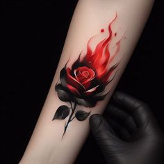 a person with a tattoo on their arm is holding a red rose and black leaves