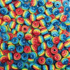 multicolored donuts are stacked on top of each other