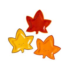 three star shaped plates with faces drawn on them, one orange and the other red