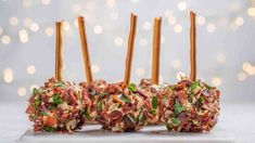 several appetizers are arranged on a plate with toothpicks sticking out of them