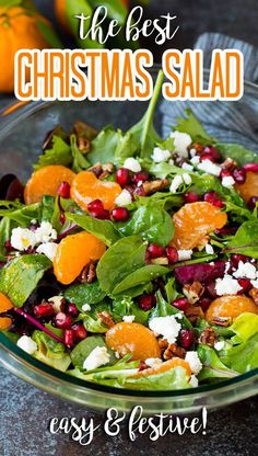 a salad with oranges, spinach and feta cheese on top in a glass bowl