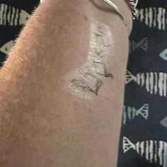 a person with a small tattoo on their arm